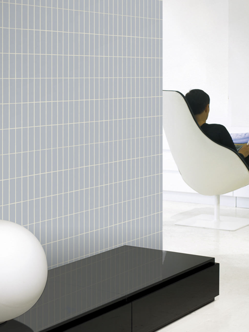 Contemporary tiled wall with minimalist decor in a modern interior setting.