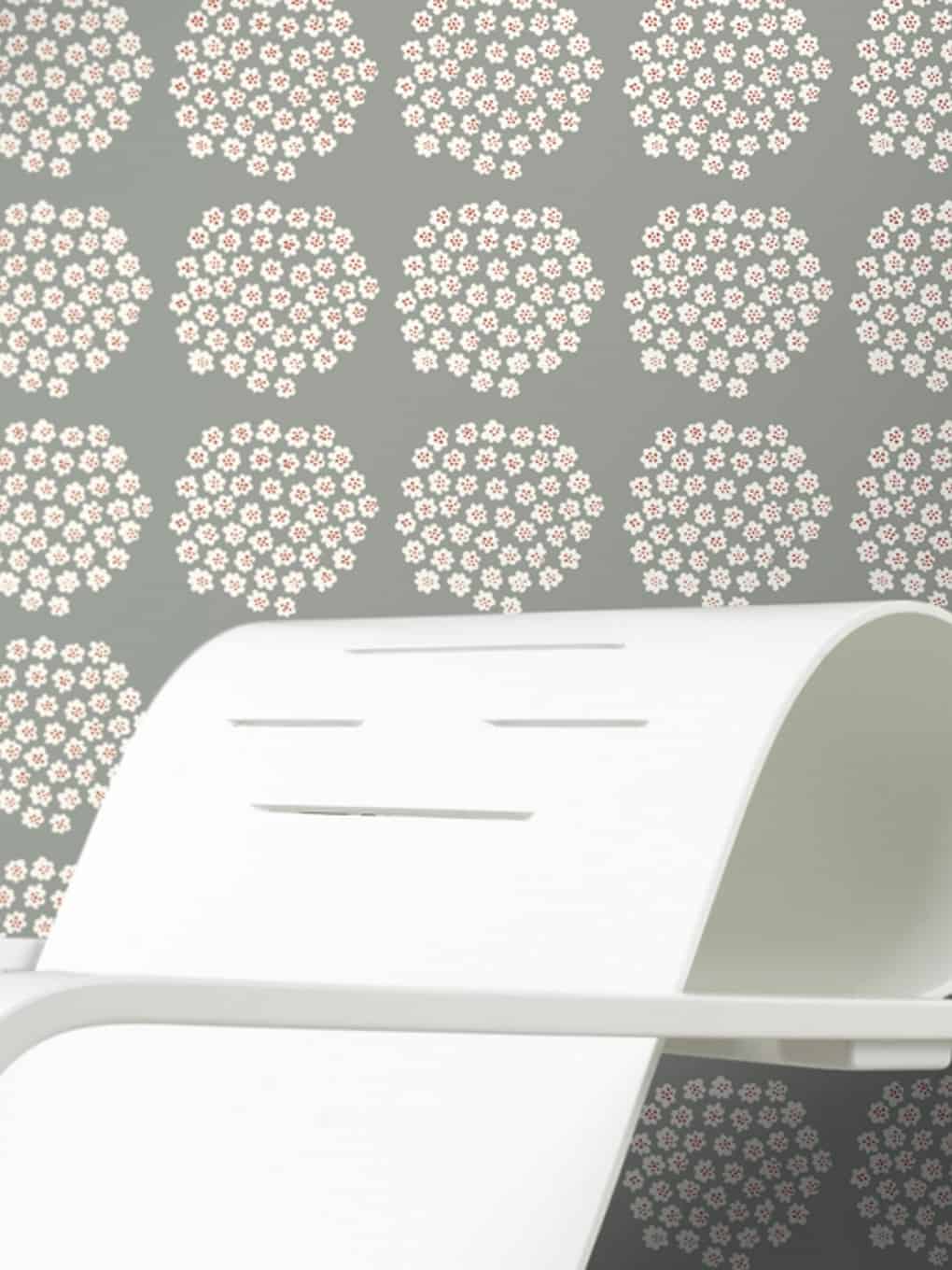 Decorative floral wallpaper with pink and white flowers on a light background.