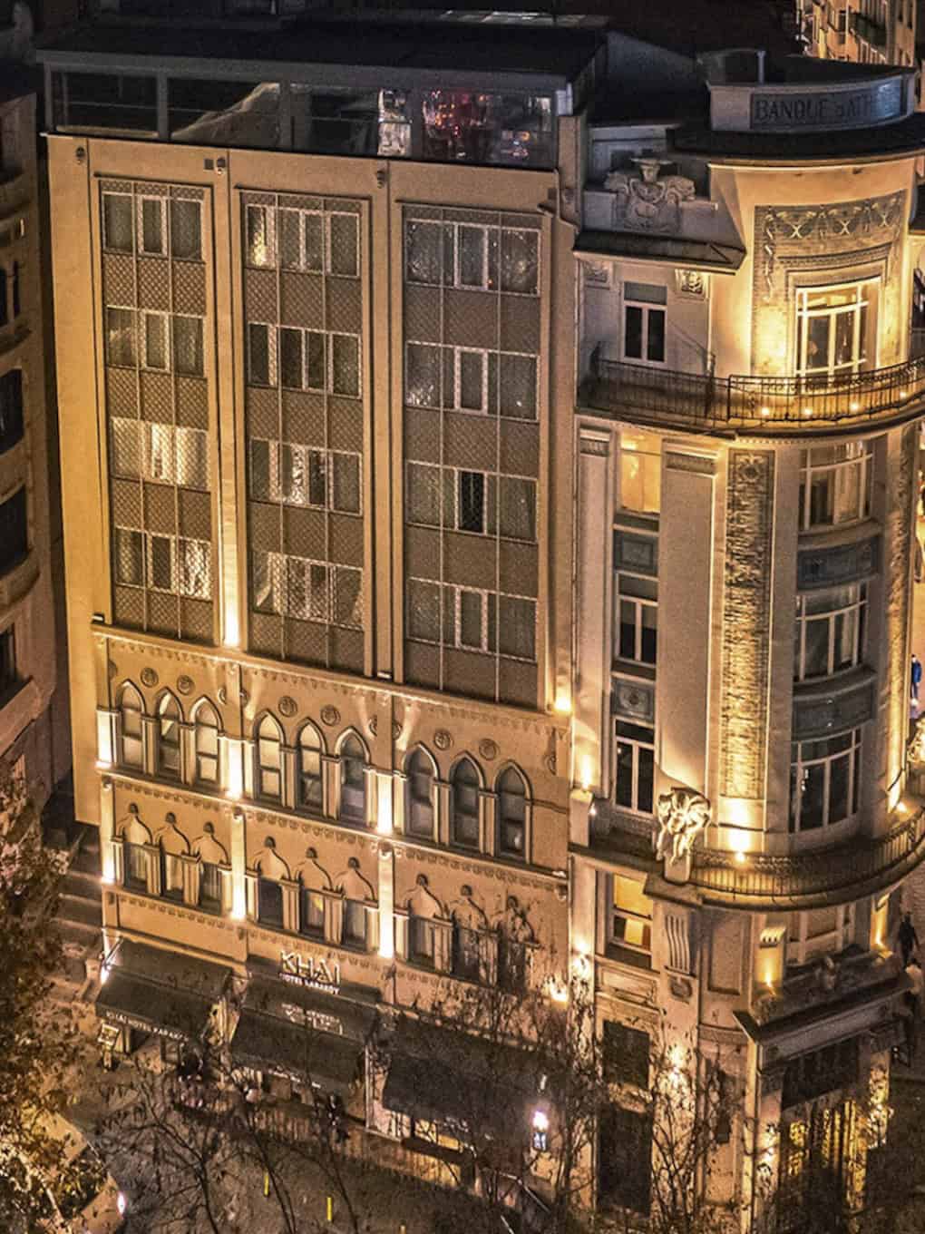 Khai Hotel Karaköy building facade at night with illuminated windows and historic architecture.