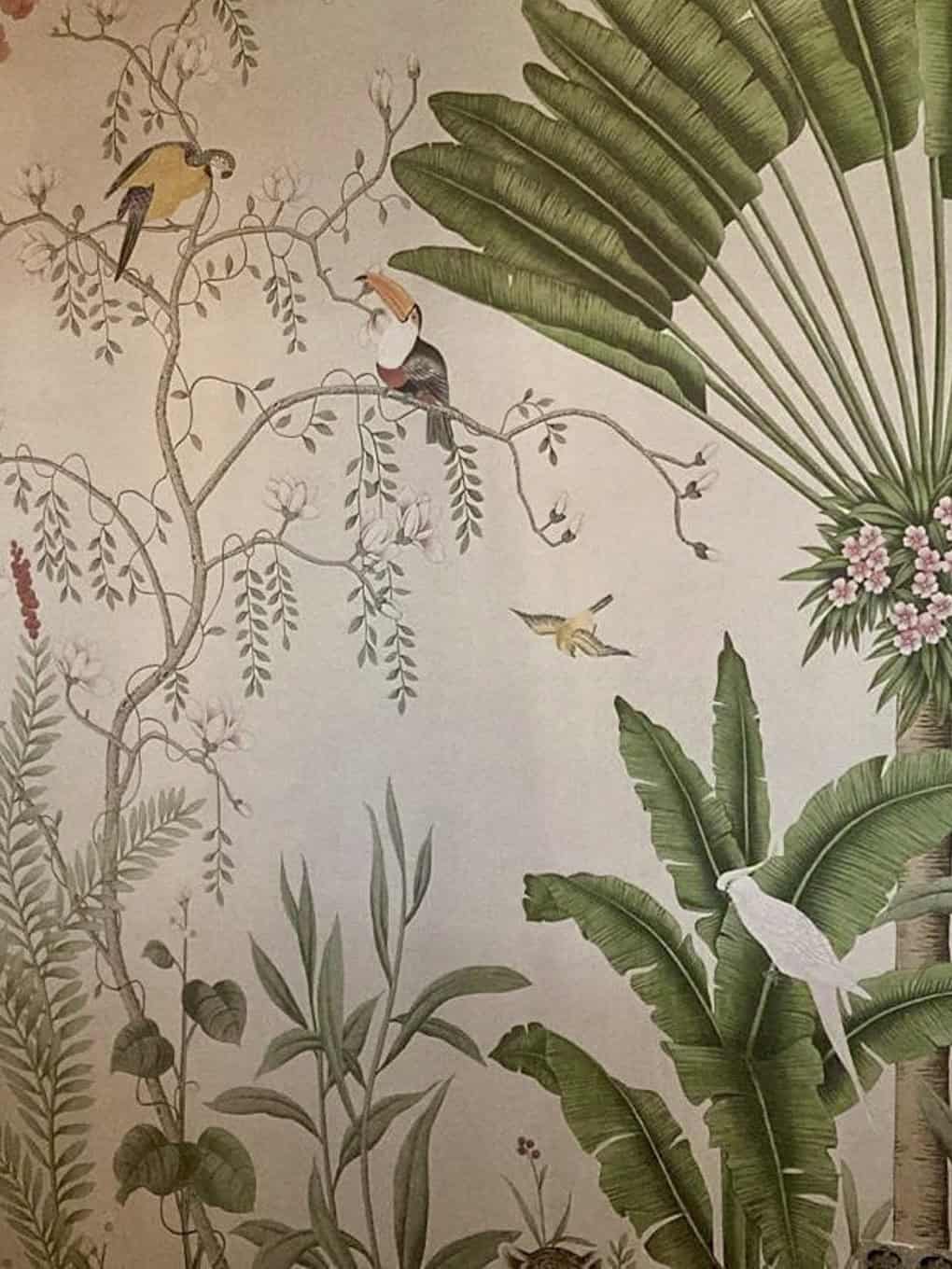 Exotic tropical wall mural with lush green banana leaves and colorful birds.